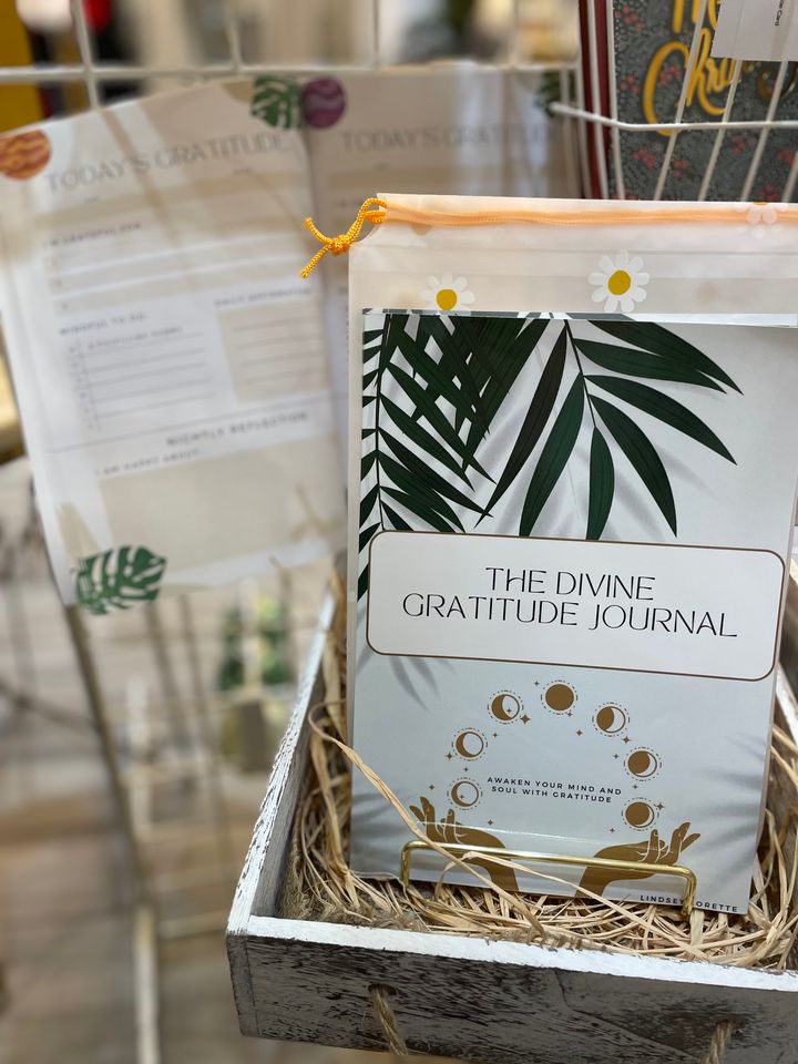 The Divine Gratitude Journal in a gift crate with straw in a local shop.